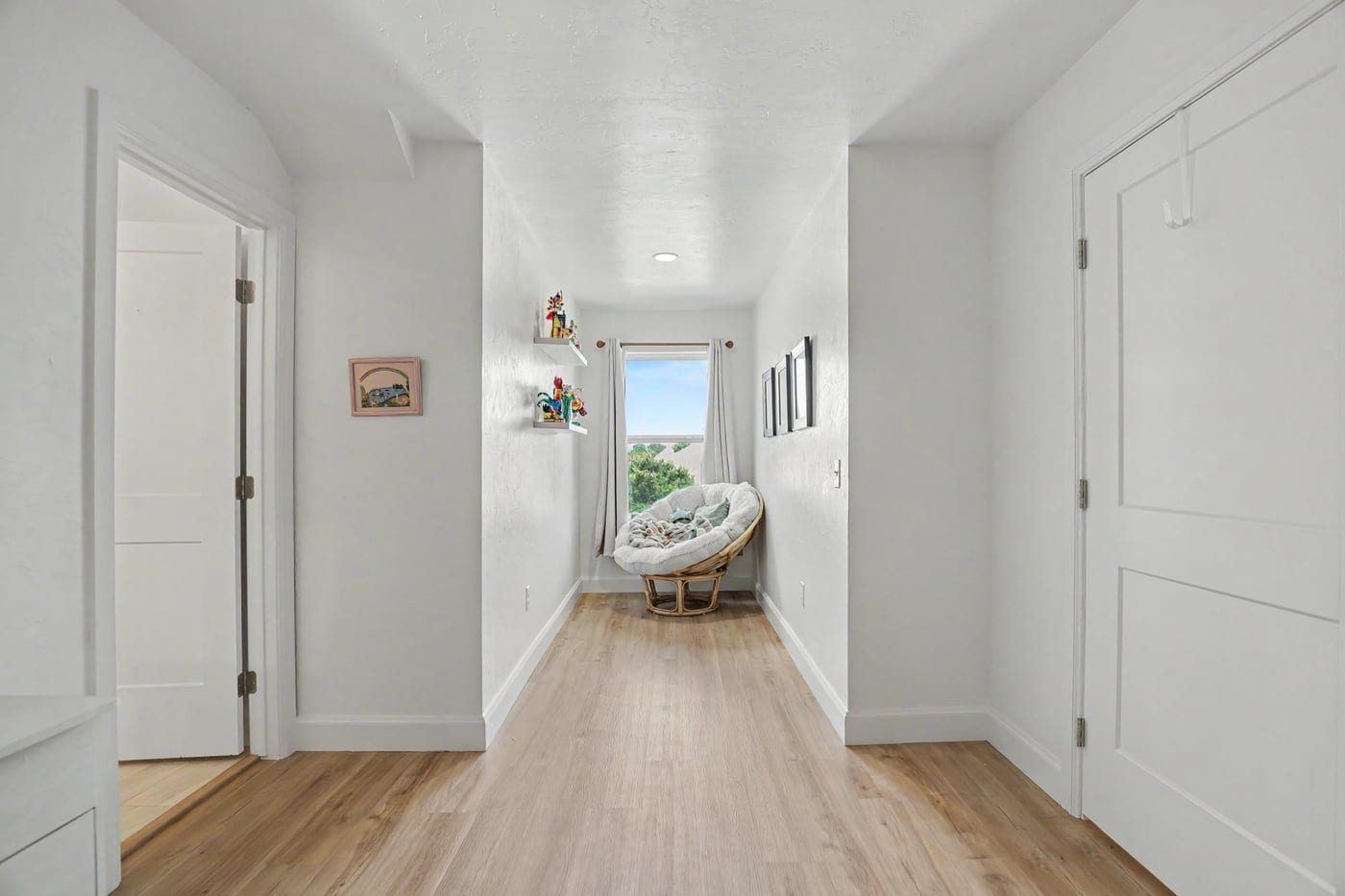 Attic hallway leading to a window reading nook