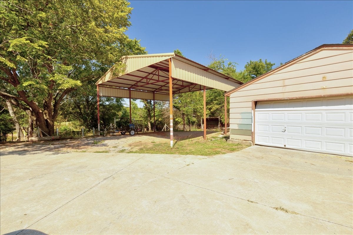 Old metal carport on the lot before construction