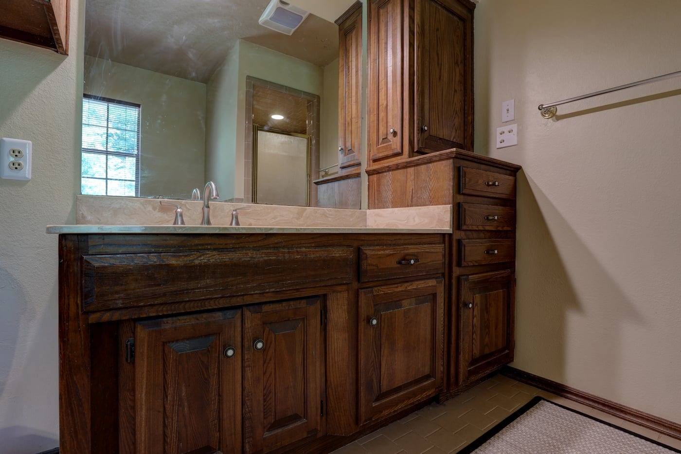 Dark wood vanity and linen cabinet before the remodel