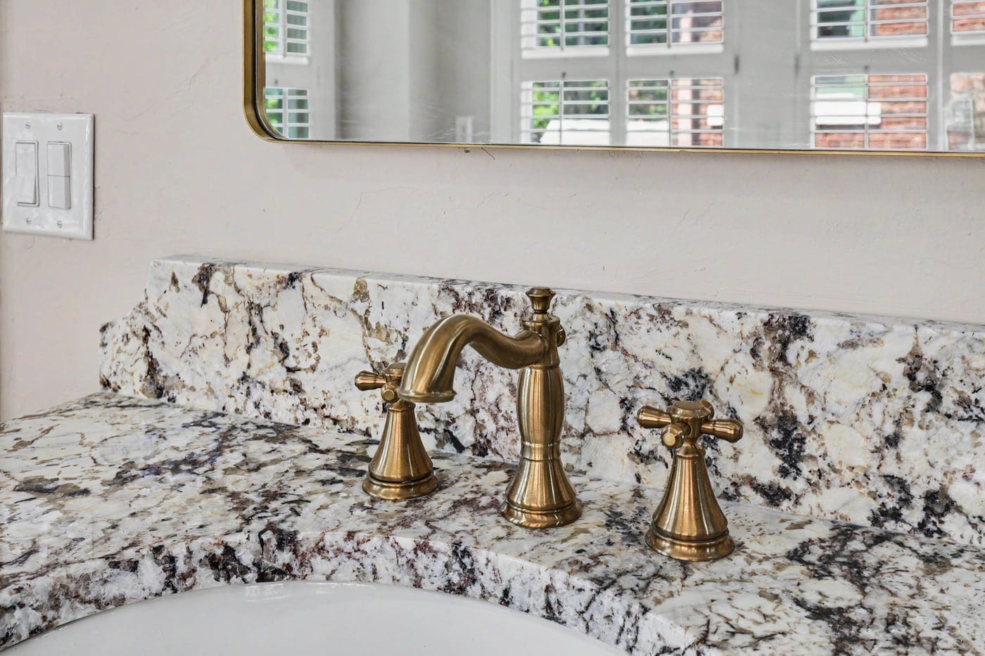 Brass faucet on a stone vanity top