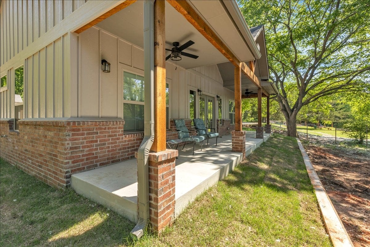 Covered porch with ceiling fan and cedar posts
