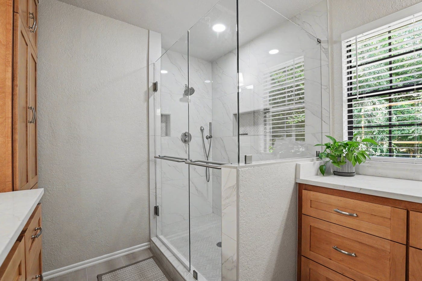 Frameless glass walk-in shower with built-in niche