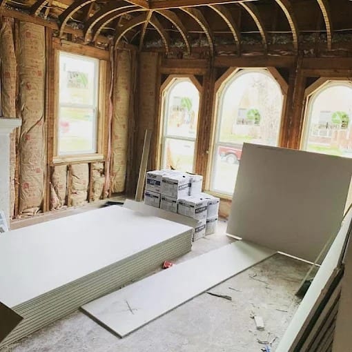 Attic conversion in progress with insulation and arched windows