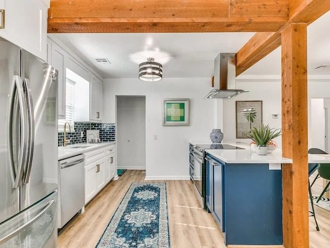 Kitchen remodel with blue island and exposed beams