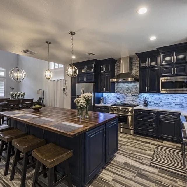 Dark cabinet kitchen with butcher block island