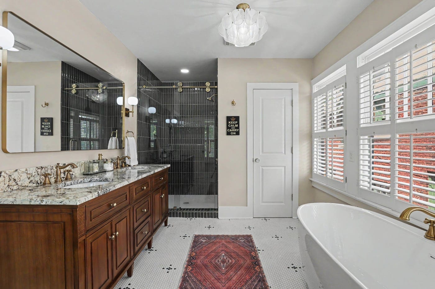 Primary bathroom remodel in Oklahoma City with freestanding tub, green tile shower and wood double vanity